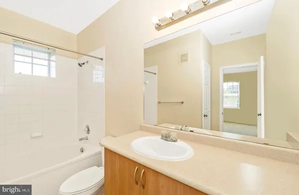 a bathroom with a sink toilet tub and shower