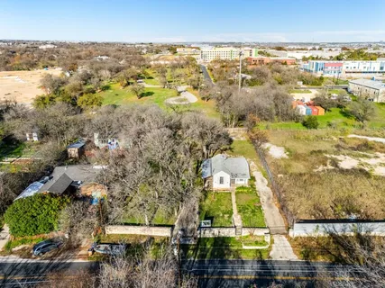 an aerial view of residential houses with outdoor space