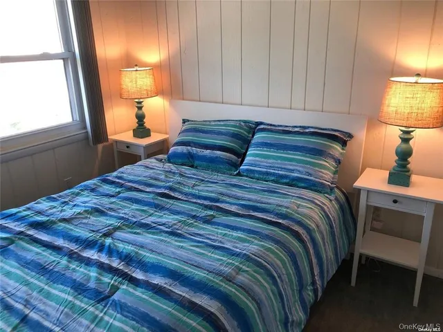 a bedroom with a bed and a lamp