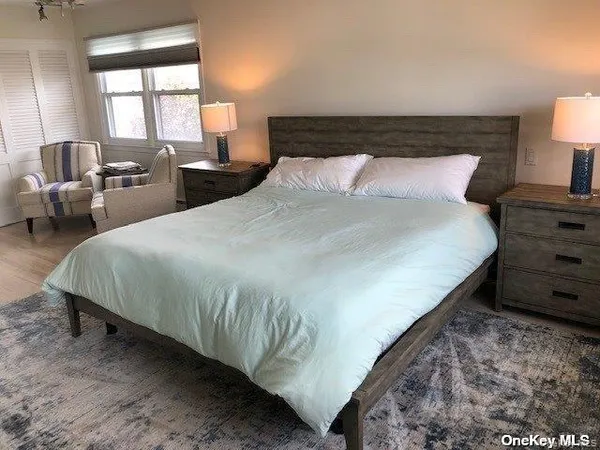 a large bed sitting in a bedroom next to a window