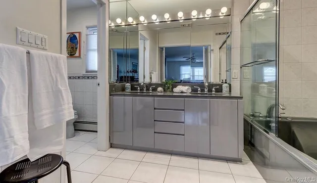 a bathroom with a double vanity sink and a mirror