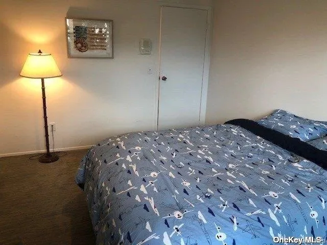 a bedroom with a bed and a lamp