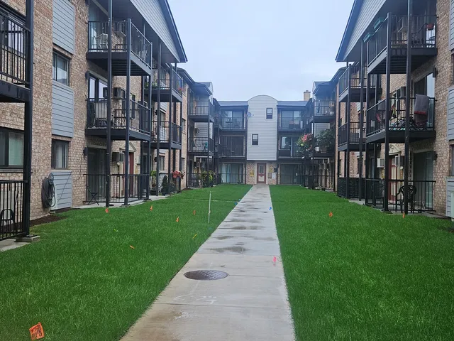 a view of a brick building next to a big yard