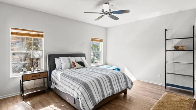 a bedroom with a bed and wooden floor