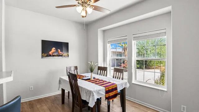 a kitchen with a refrigerator a stove a sink dishwasher with a dining table and chair