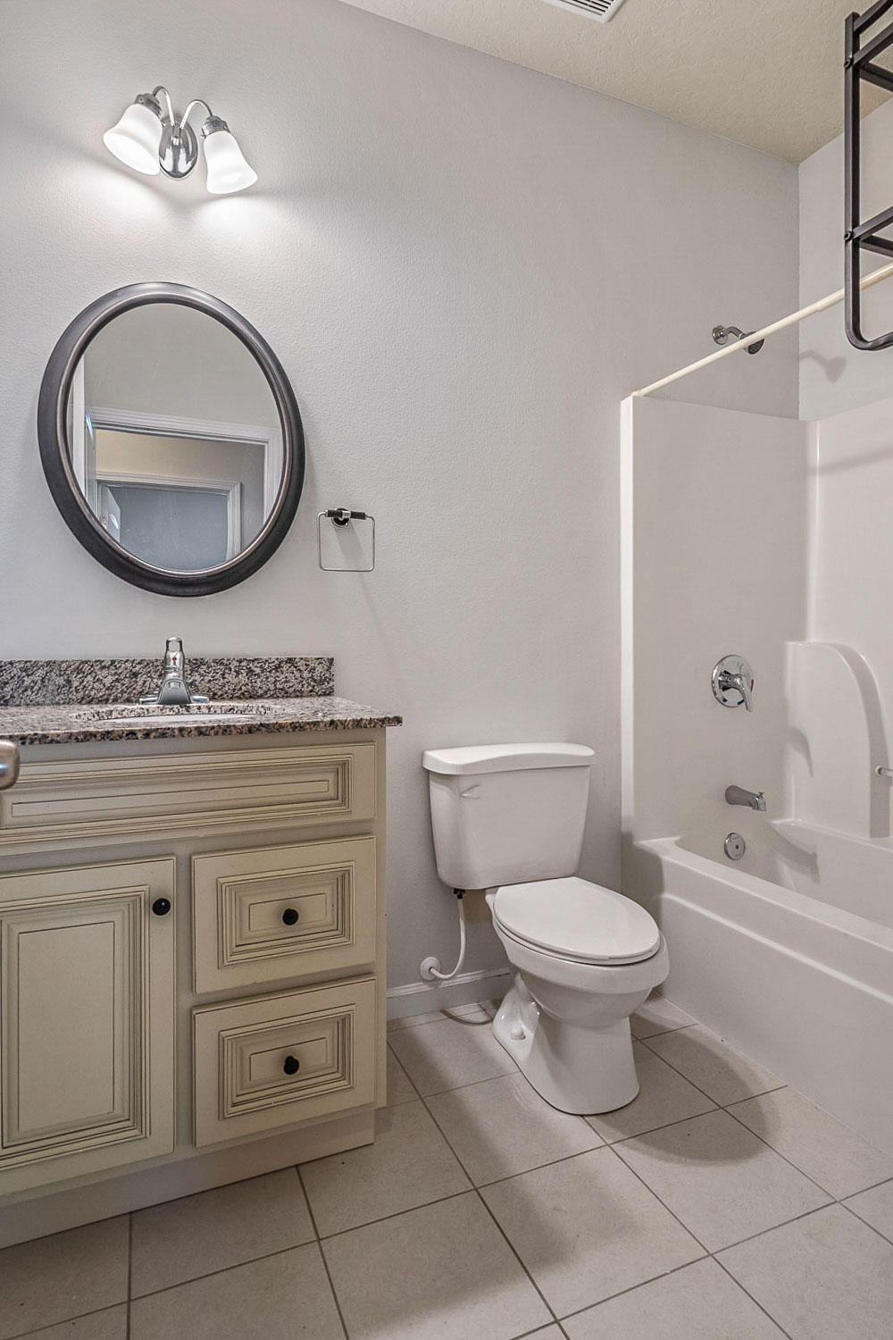 4592 Hermosa Road Crestview, FL 32539 - Photo 17 of 32 a bathroom with a granite countertop toilet sink and mirror