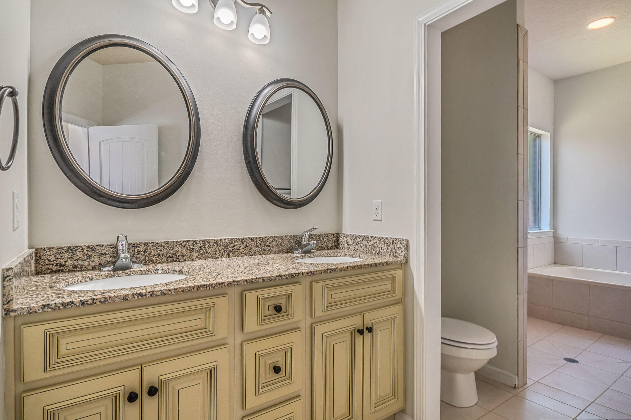 4592 Hermosa Road Crestview, FL 32539 - Photo 26 of 32 a bathroom with a granite countertop toilet a sink and a mirror