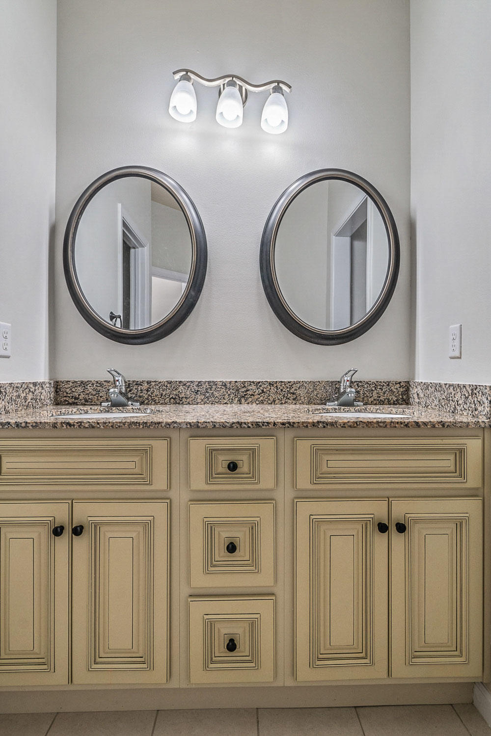 4592 Hermosa Road Crestview, FL 32539 - Photo 27 of 32 a bathroom with a granite countertop double vanity and a mirror