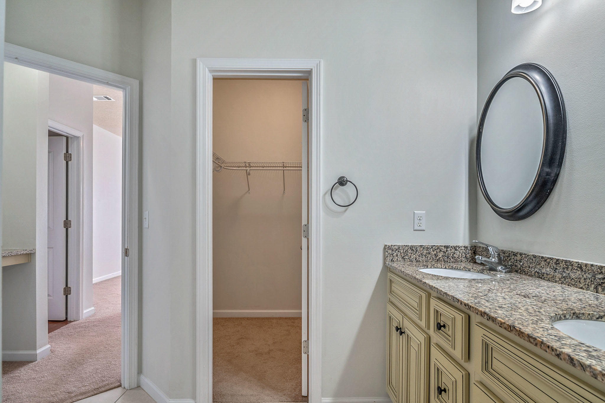 4592 Hermosa Road Crestview, FL 32539 - Photo 29 of 32 a bathroom with a granite countertop double vanity sink and a mirror