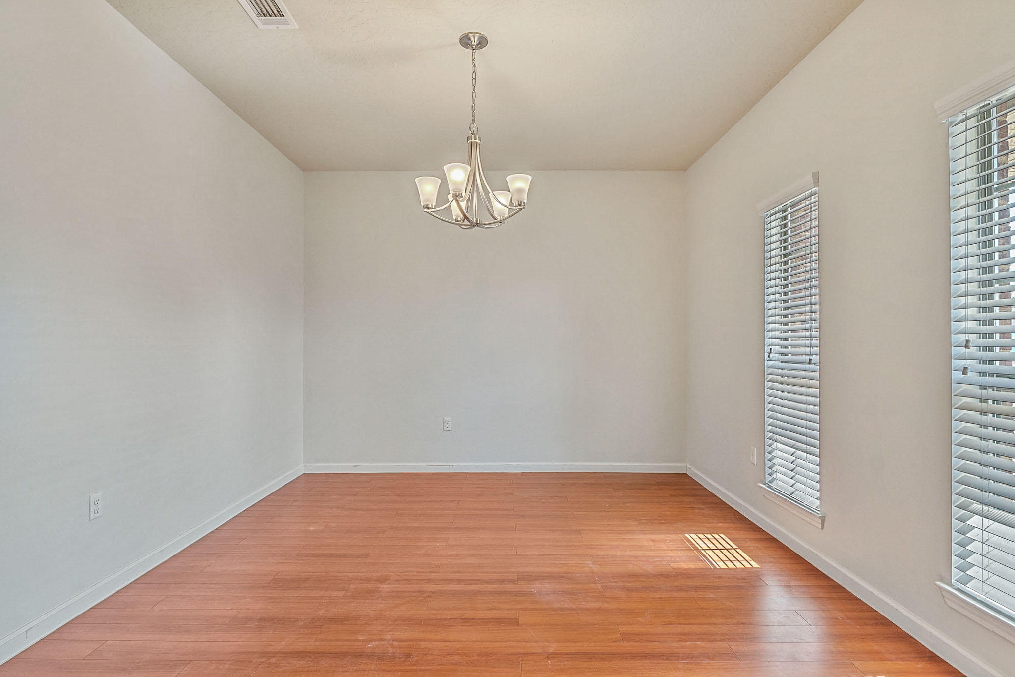 4592 Hermosa Road Crestview, FL 32539 - Photo 5 of 32 a view of empty room with wooden floor and fan