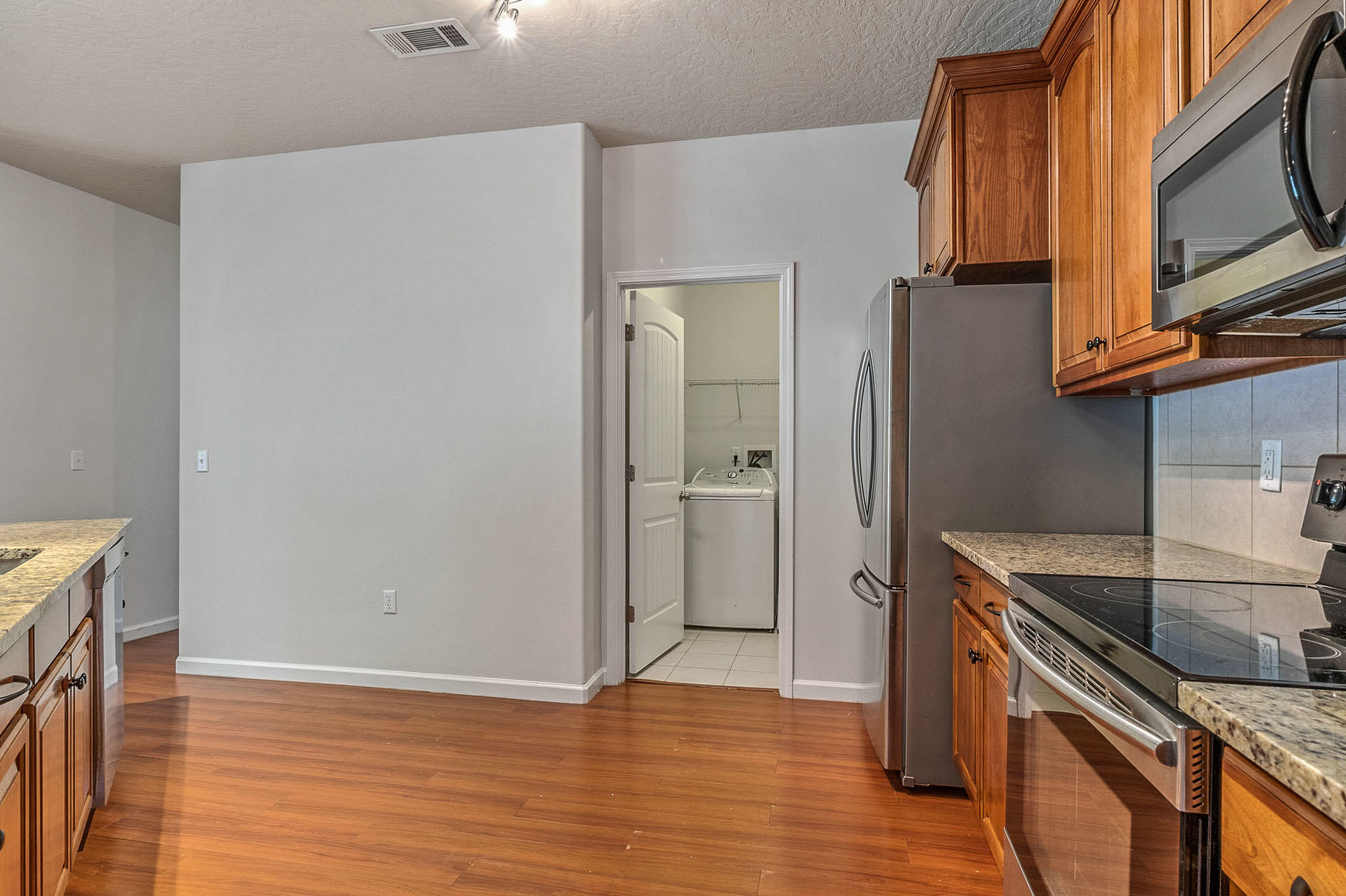 4592 Hermosa Road Crestview, FL 32539 - Photo 8 of 32 a view of a kitchen with wooden floor and electronic appliances