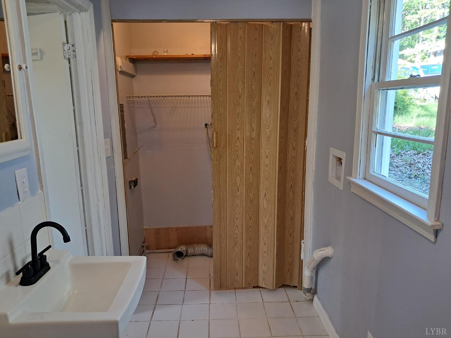 6019 Wards Road Evington, VA 24550 - Photo 17 of 32 a bathroom with a sink and a mirror