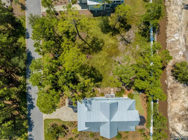 an aerial view of a house with a yard