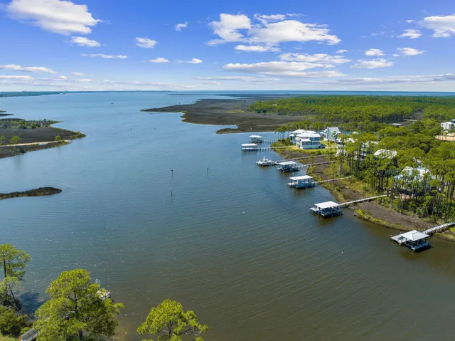 a view of house with swimming pool and green space