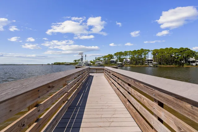 a view of a terrace with seating space and lake view