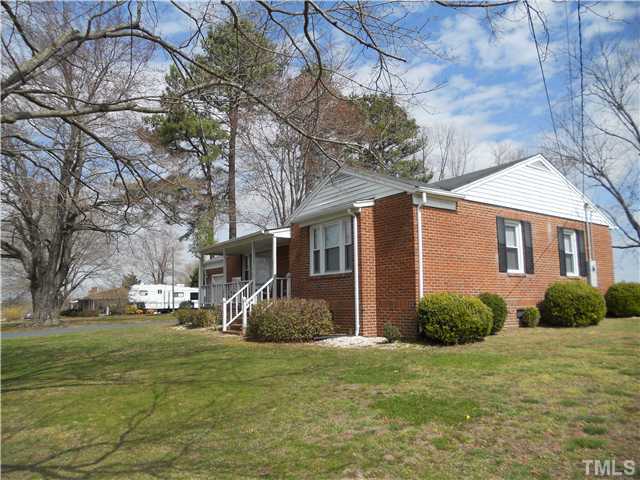 2505 Old Durham Road Roxboro, NC 27573 - Photo 2 of 18 a front view of a house with garden