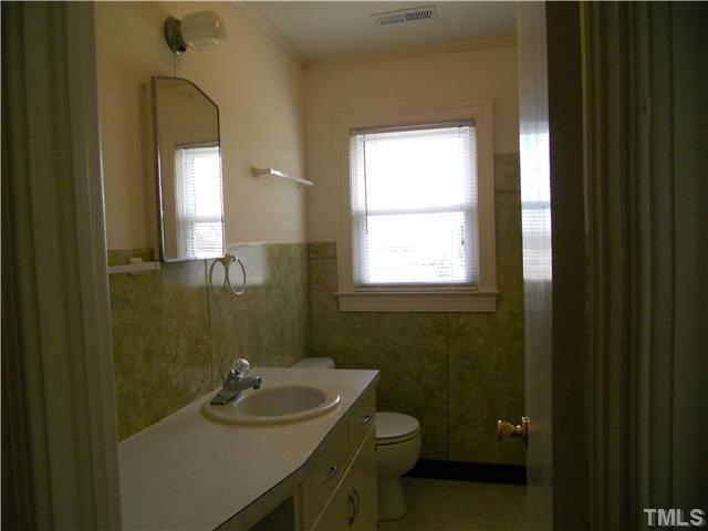 2505 Old Durham Road Roxboro, NC 27573 - Photo 16 of 18 a bathroom with a sink a toilet and a mirror