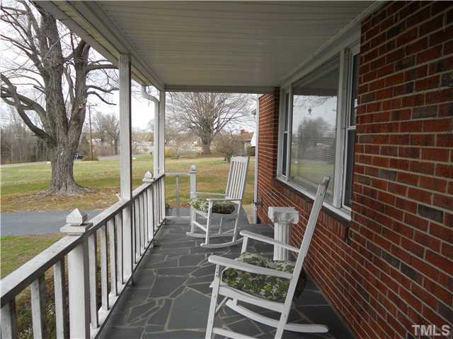 2505 Old Durham Road Roxboro, NC 27573 - Photo 4 of 18 a view of balcony with wooden floor and outdoor seating