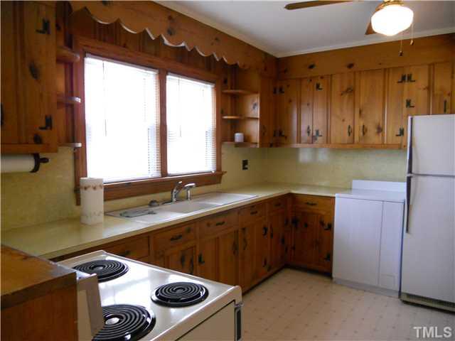 2505 Old Durham Road Roxboro, NC 27573 - Photo 10 of 18 a kitchen with a sink and a stove next to a window