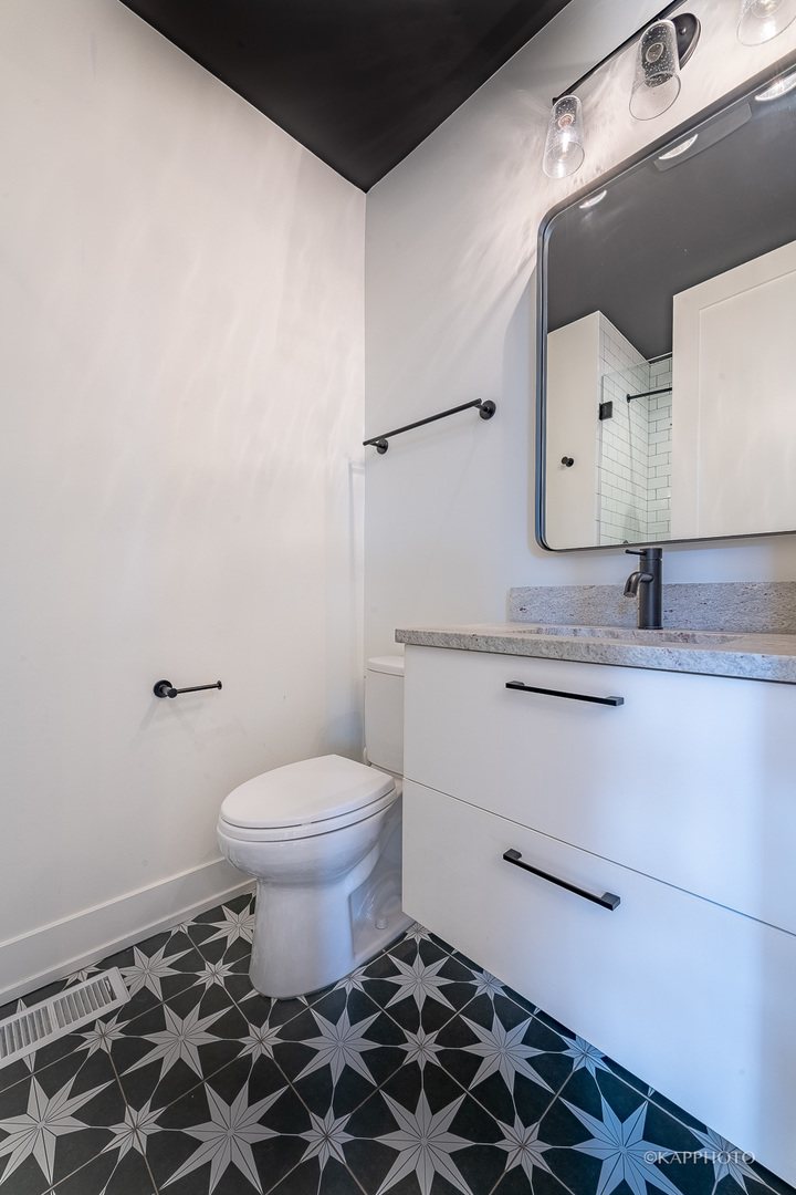 15 North Ada Street Chicago, IL 60607 - Photo 18 of 41 a bathroom with a granite countertop sink toilet and shower