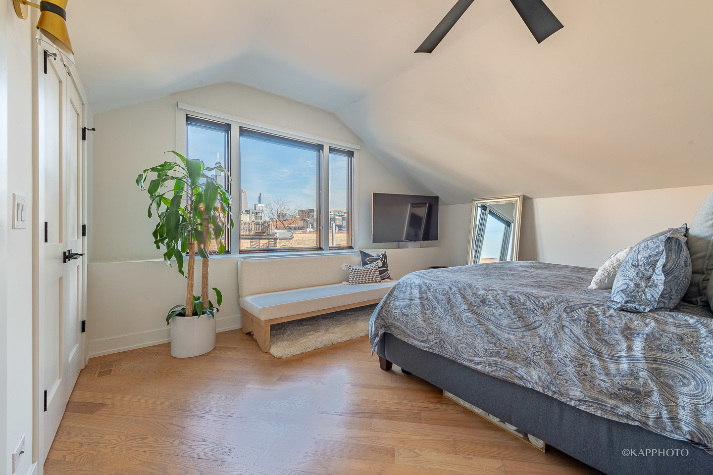 15 North Ada Street Chicago, IL 60607 - Photo 27 of 41 a spacious bedroom with a bed and a potted plant