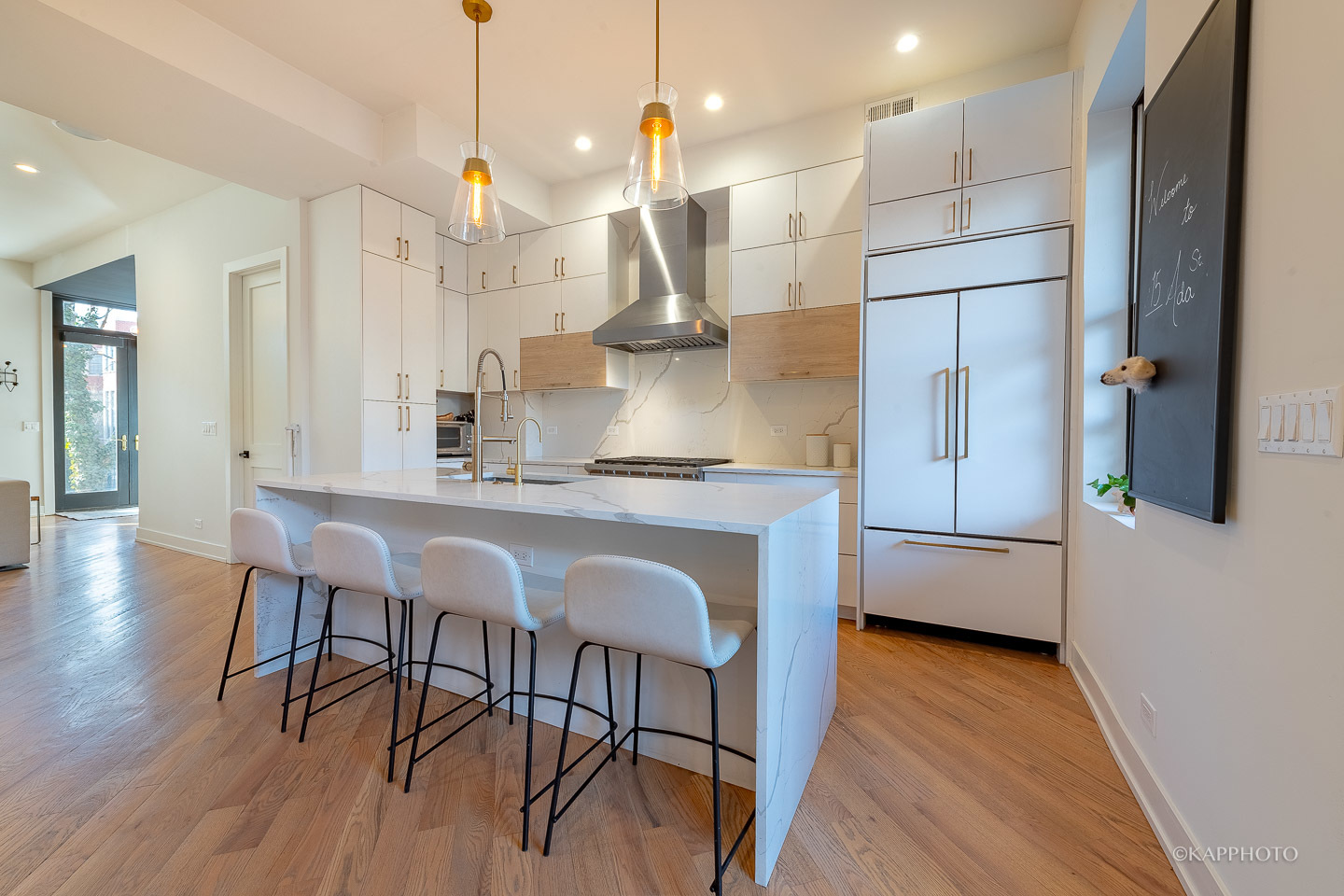15 North Ada Street Chicago, IL 60607 - Photo 10 of 41 a kitchen with stainless steel appliances granite countertop a kitchen island hardwood floor and a sink