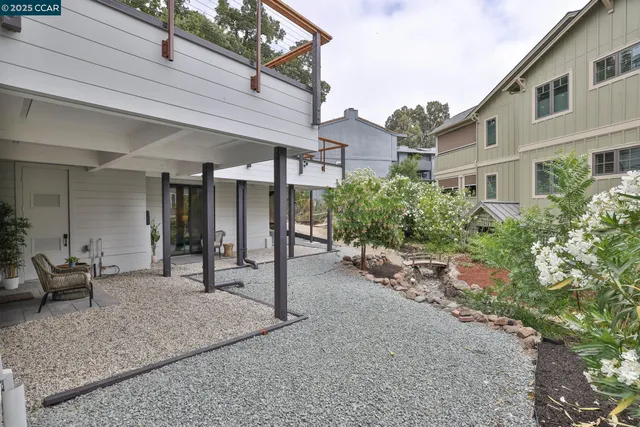 a view of a house with backyard and sitting area