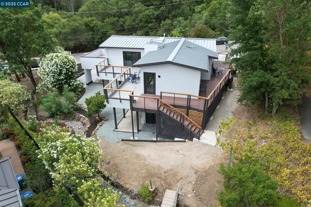 an aerial view of a house with a yard and sitting area