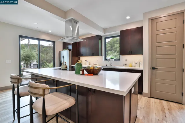 a kitchen with a sink cabinets and wooden floor