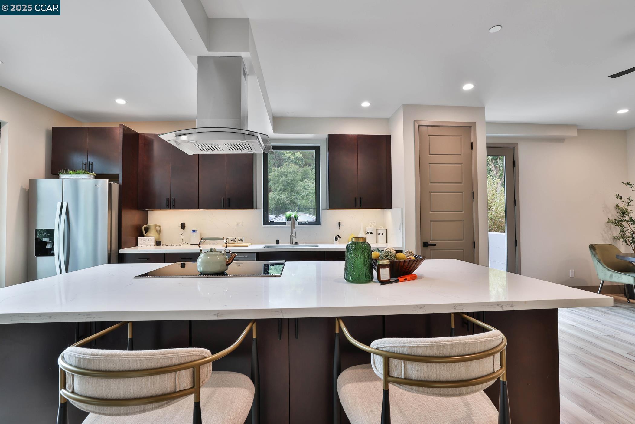 946 Risa Road, Unit A Lafayette, CA 94549 - Photo 3 of 17 a kitchen with a table chairs stove and kitchen island