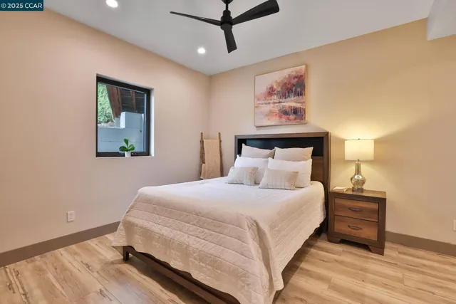 a bedroom with a bed and wooden floor