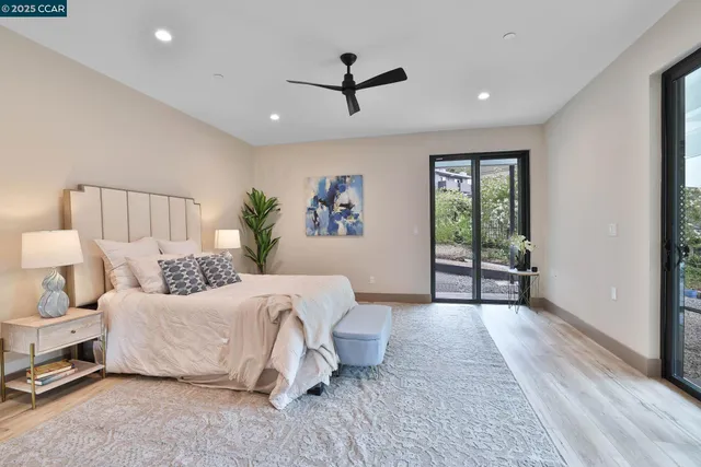 a spacious bedroom with a bed and a window