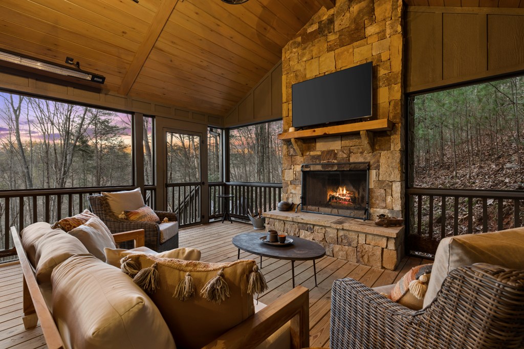 106 Little Rock Creek Road Cherry Log, GA 30522 - Photo 38 of 95 a living room with furniture a fireplace and a flat screen tv