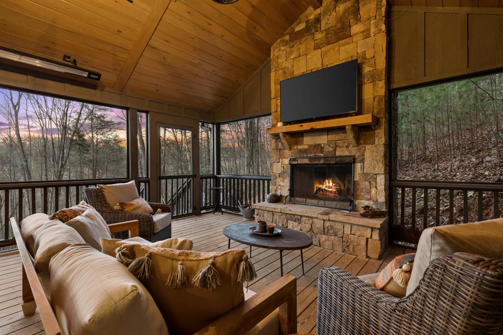 106 Little Rock Creek Road Cherry Log, GA 30522 - Photo 94 of 95 a living room with furniture a fireplace and a flat screen tv