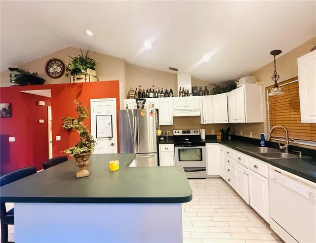 a view of a room with wooden floor and windows
