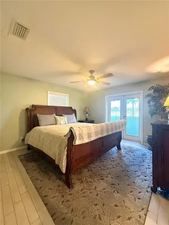 a bed sitting in a bedroom next to a window