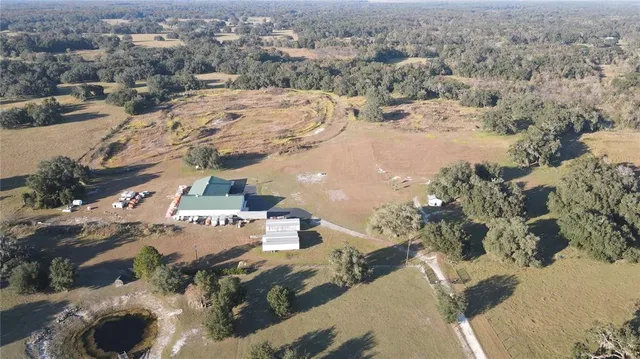 a kitchen with stainless steel appliances a sink a stove top oven a chimney and a refrigerator