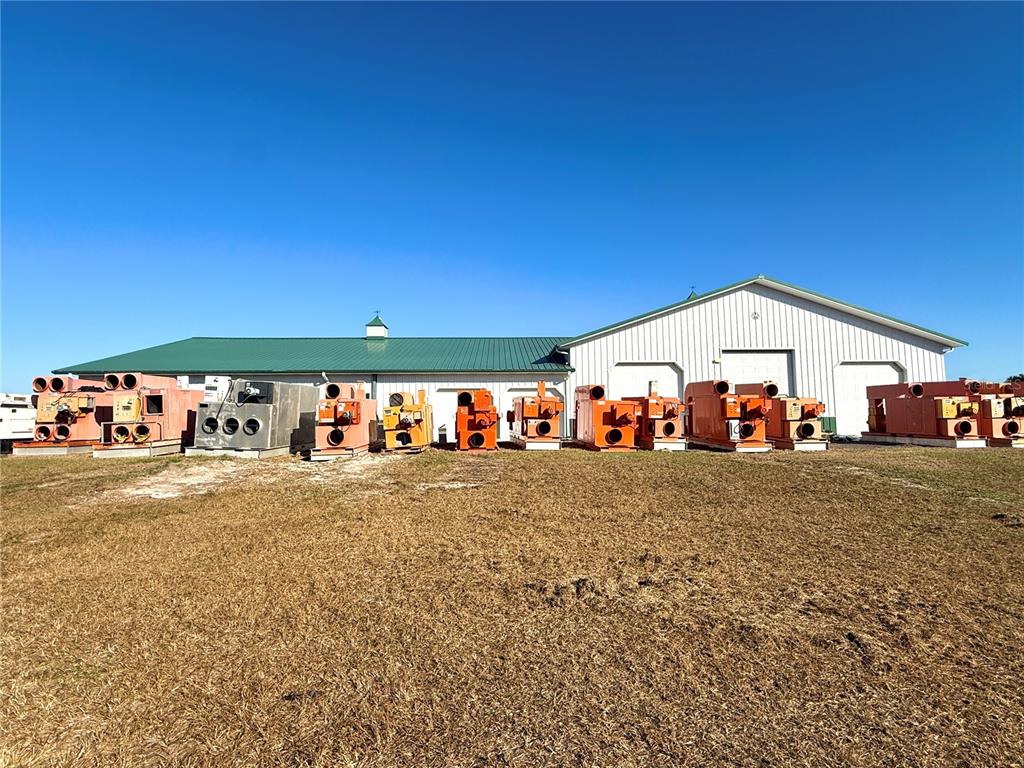 7223 South W 55 Street Bushnell, FL 33513 - Photo 61 of 70 a view of a house with a yard and garage
