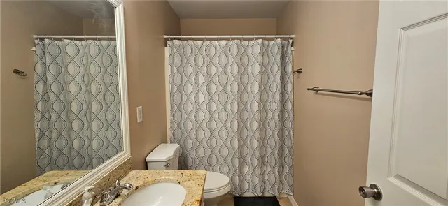 a bedroom with furniture and a flat screen tv