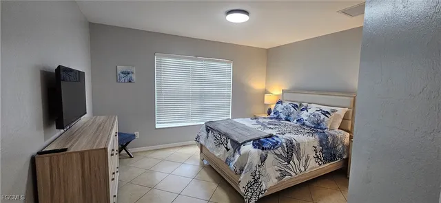 a bed sitting in a bedroom next to a window