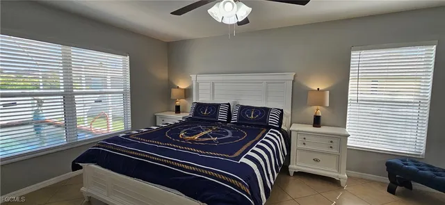 a bedroom with a bed and a flat tv screen on a dresser
