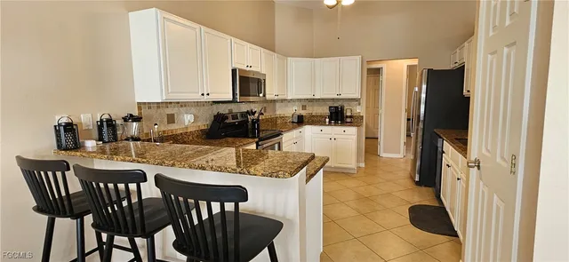 a living room with furniture and a lamp