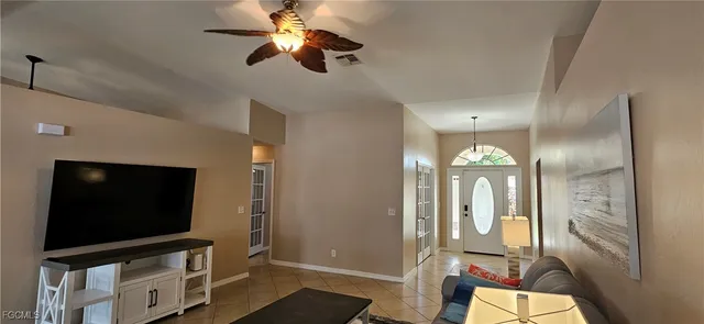 a dining room with furniture and a floor to ceiling window
