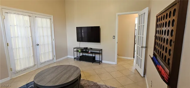 a living room with furniture and a lamp