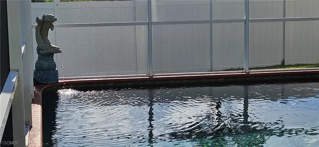 a bedroom with a bed and a flat tv screen on a dresser