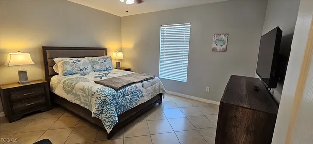 a bedroom with a bed and a television