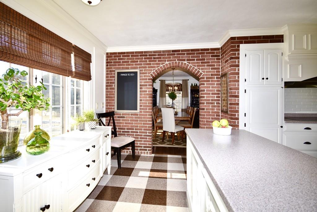 86 Snipatuit Road Rochester, MA 02770 - Photo 15 of 36 a hallway with a black white checkered floor next to a large window