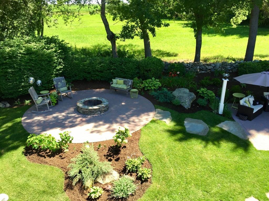 86 Snipatuit Road Rochester, MA 02770 - Photo 34 of 36 a view of a garden with a bench in the garden