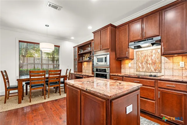 a dining room with furniture window and wooden floor