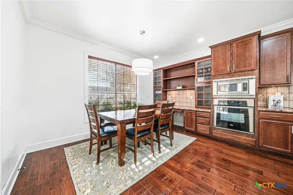 a spacious bathroom with a granite countertop sink a toilet a mirror and shower